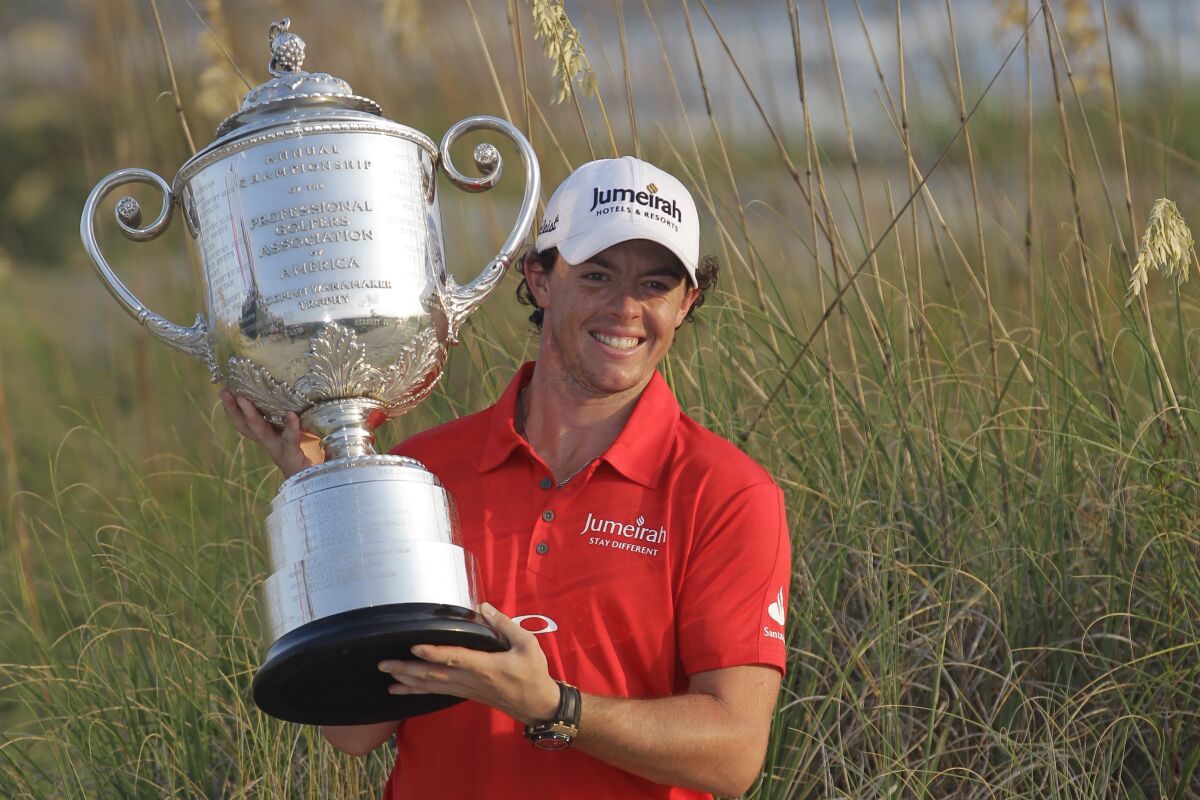 FILE - Rory McIlroy of Northern Ireland poses for photographers with the championship trophy after the final round of the PGA Championship golf tournament on the Ocean Course of the Kiawah Island Golf Resort in Kiawah Island, S.C., in this Sunday, Aug. 12, 2012, file photo. McIlroy is the favorite when the PGA Championship returns to Kiawah on May 20-23, 2021. (AP Photo/John Raoux, File)