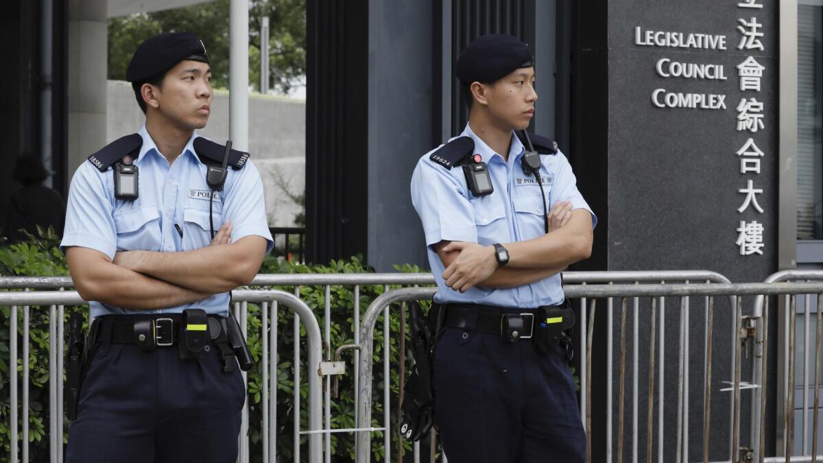 Hong Kong police stand guard Tuesday near the Legislative Council building in anticipation of protests as the government takes up a controversial extradition measure.