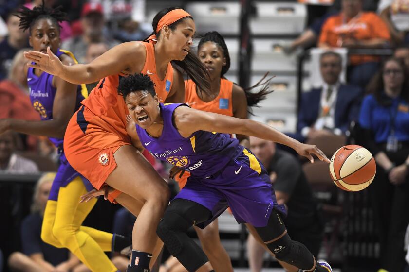 Connecticut's Brionna Jones, left, fouls Sparks Alana Beard during the first half of a WNBA basketball playoff game, Tuesday, Sept. 17, 2019, in Uncasville, Conn. (AP Photo/Jessica Hill)