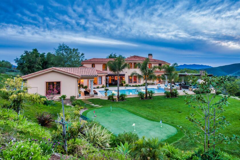 The 1.5-acre estate includes a 7,500-square-foot villa, pool house, swimming pool, spa, putting green and pavilion.