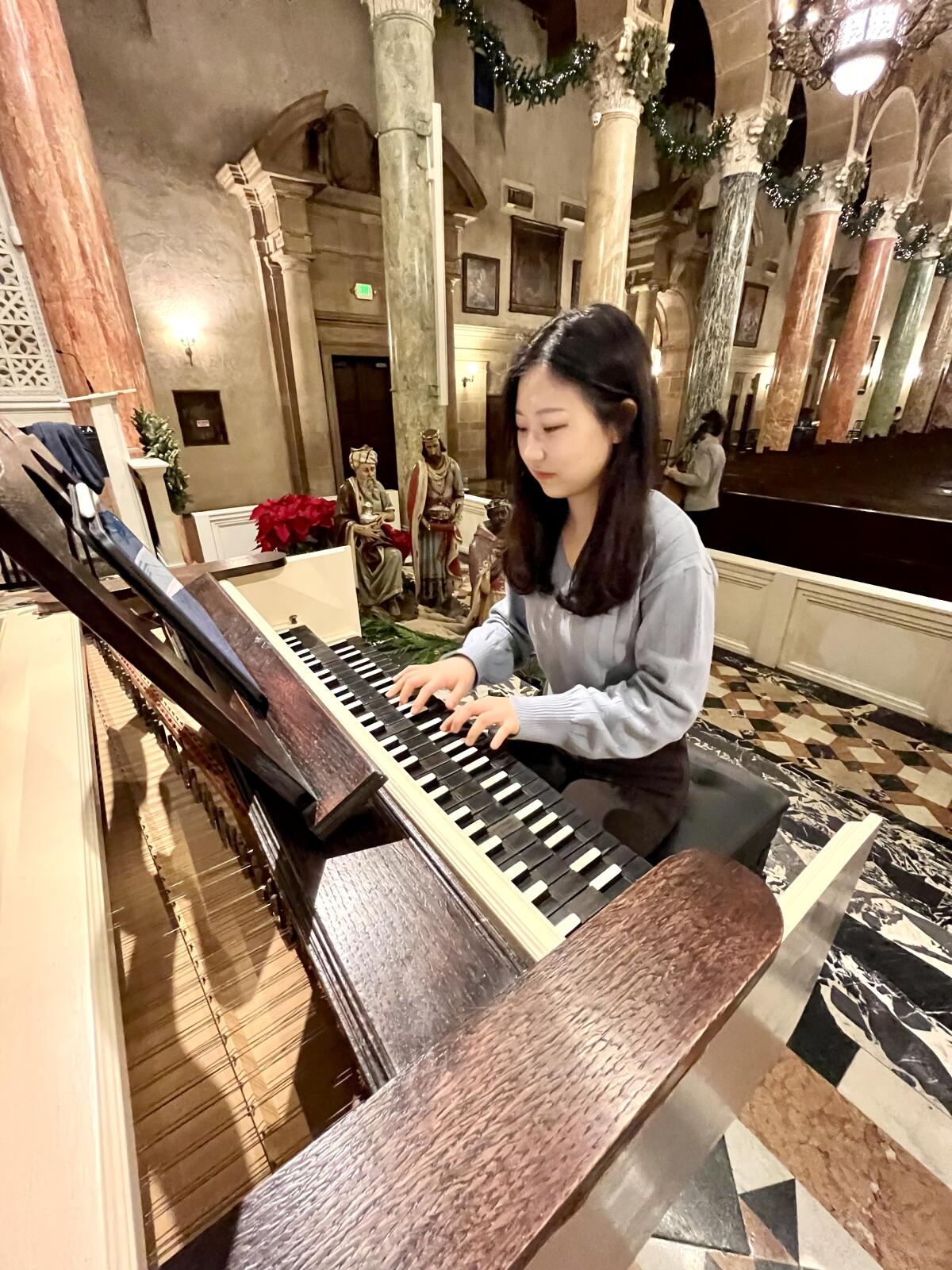 Bogang Hwang plays the harpsichord at rehearsal at St. Andrew's Catholic Church.