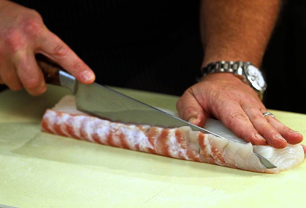 Michael Cimarusti demonstrates the technique of trimming and cutting a halibut.