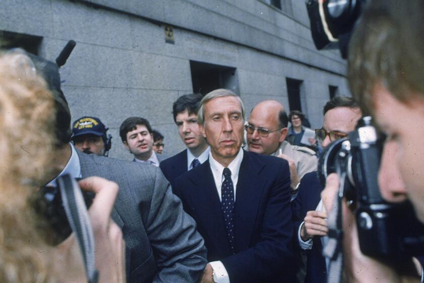 FILE - Ivan F. Boesky, center, leaves federal court in New York, April 24, 1987 after pleading guilty to one count of violating federal securities laws. Boesky, the flamboyant stock speculator whose cooperation with the government cracked open one of the largest insider trading scandals on Wall Street, has died at the age of 87. (AP Photo/G. Paul Burnett, File)