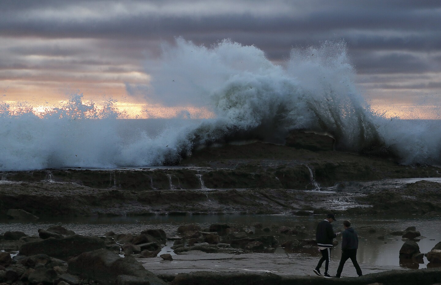 A large wave pounds the rocky shoreline at Royal Palms State Beach in San Pedro on Thursday.