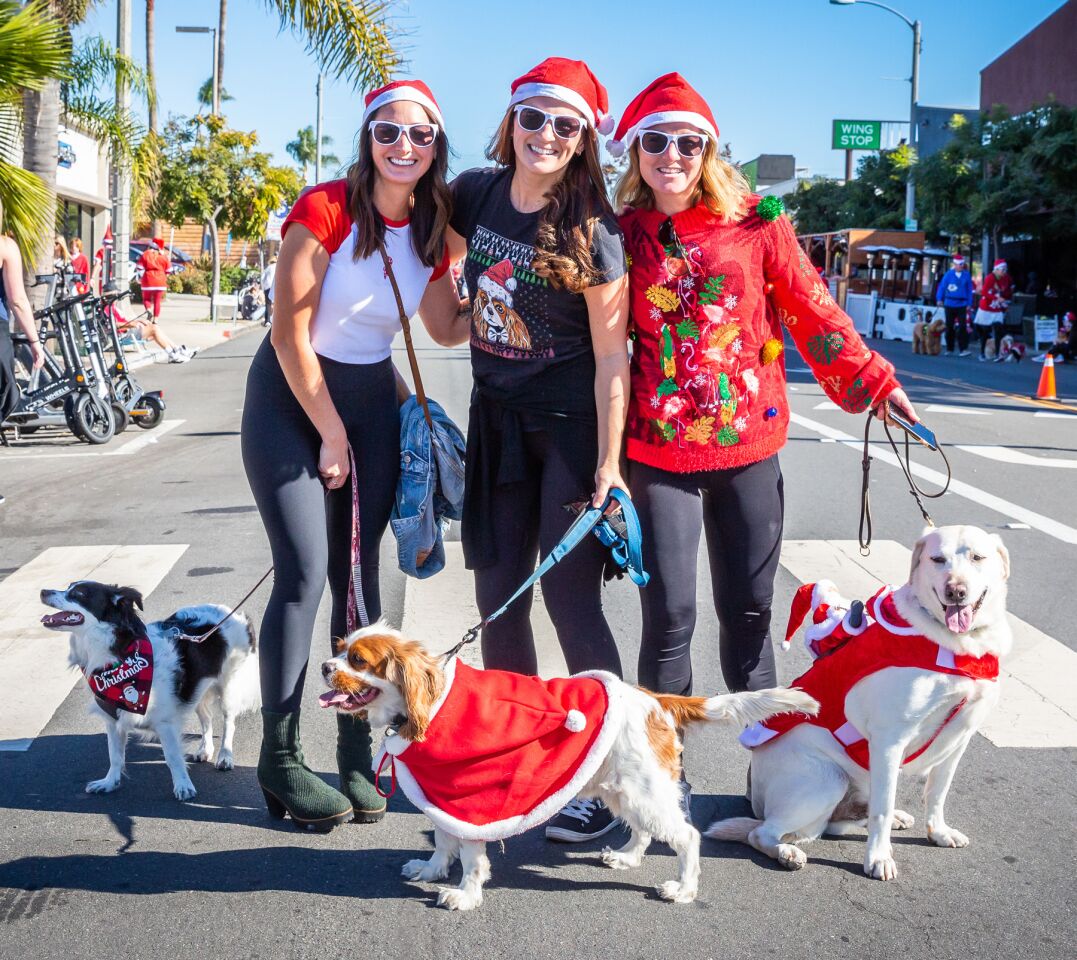 Jenny Julca with Finley, Emmy Rico with Tater Tot and Jeanie Turpin with Cooper.