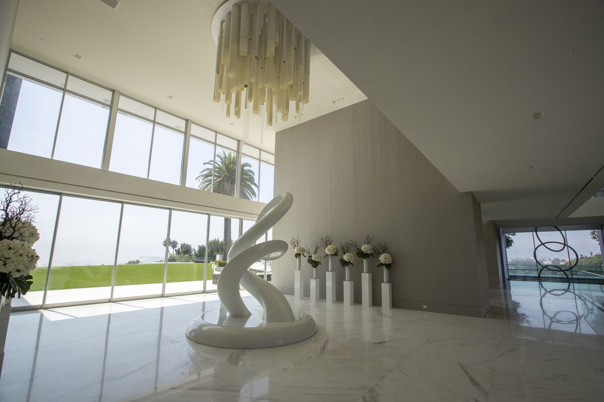 A sculpture on a rotating pedestal inside the foyer.