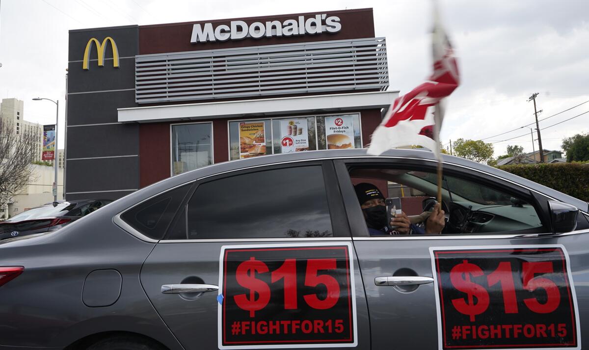 A car with signs that say #fightfor15