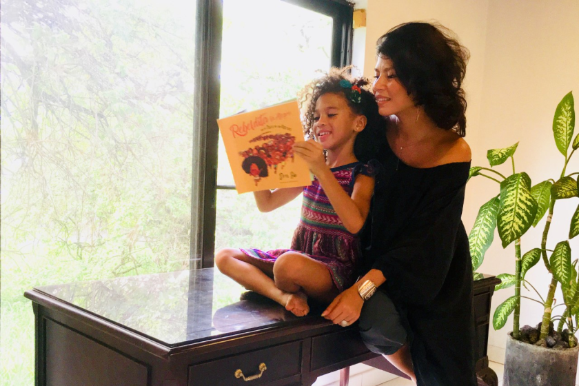Suletu, left, reads "Rebeldita" with her mother and the book's author, Oriel María Siu.