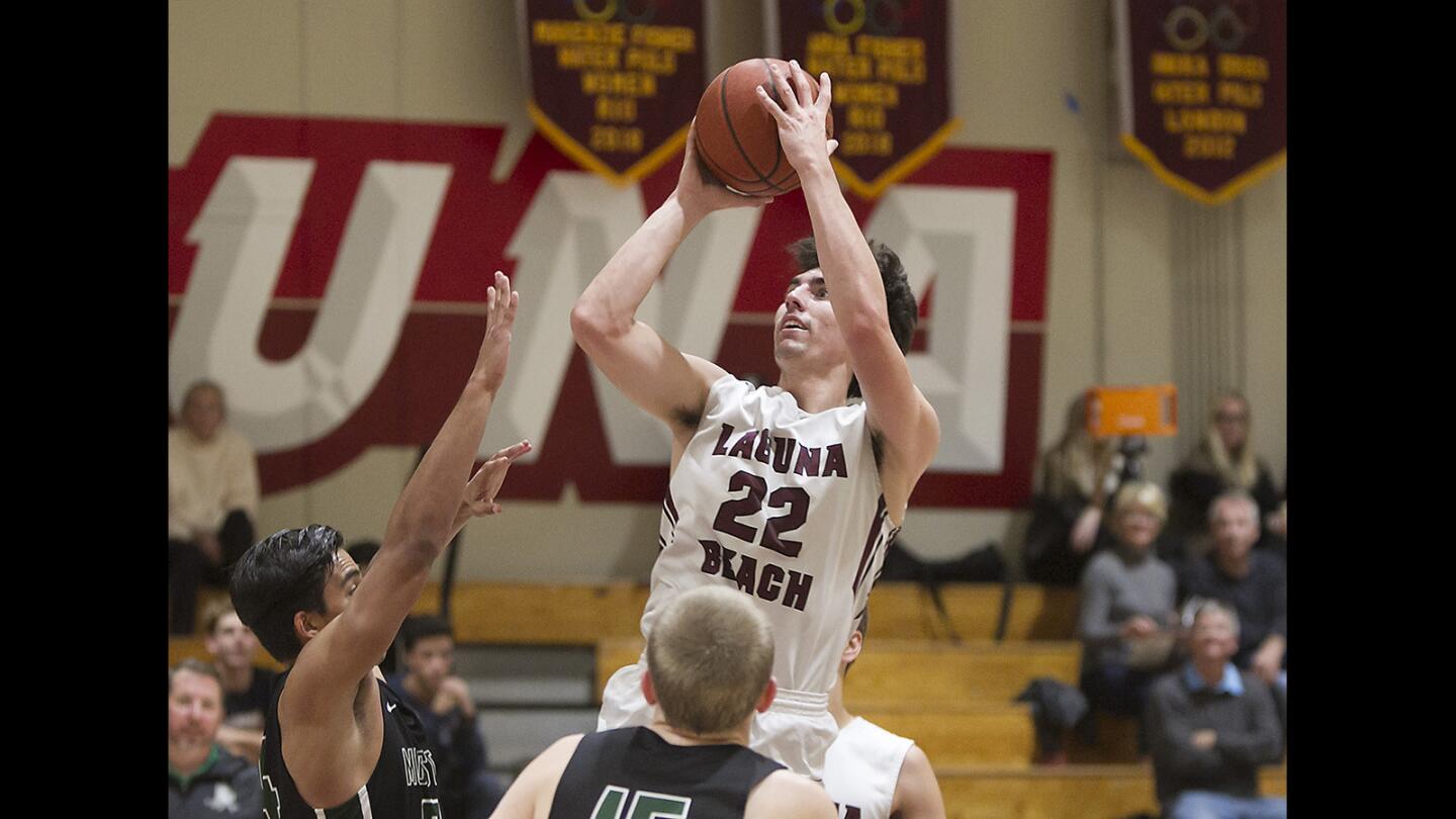 Laguna's Blake Burzell puts up a running jumper during boys varsity basketball action against Costa Mesa on Friday.