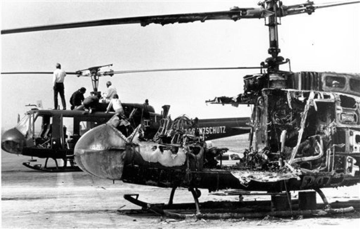 FILE - In this Sept. 7, 1972, file photo, the two West German border police helicopters that carried armed terrorists and their nine Israeli Olympian hostages, stand at Fuerstenfeldbruck air force base about 20 miles west of Munich, Germany. The helicopter in foreground is a burned out shell as a result of a hand grenade explosion set off by one of the terrorists apparently committing suicide rather than risking capture in the evening of Sept. 5. Nine of the 11 Israelis taken hostage at the Olympic Village died in the shoot-out at the air force base. Five Palestinian terrorists and a German policeman were killed in the incident, known as the "Munich massacre." (AP Photo/File)