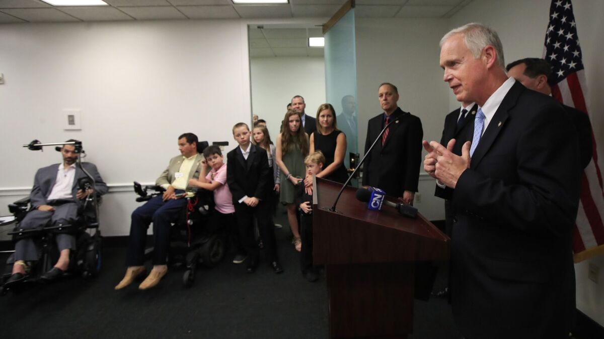 Sen. Ron Johnson, R-Wisc., right, angles for praise for passing a law that will undermine public health.