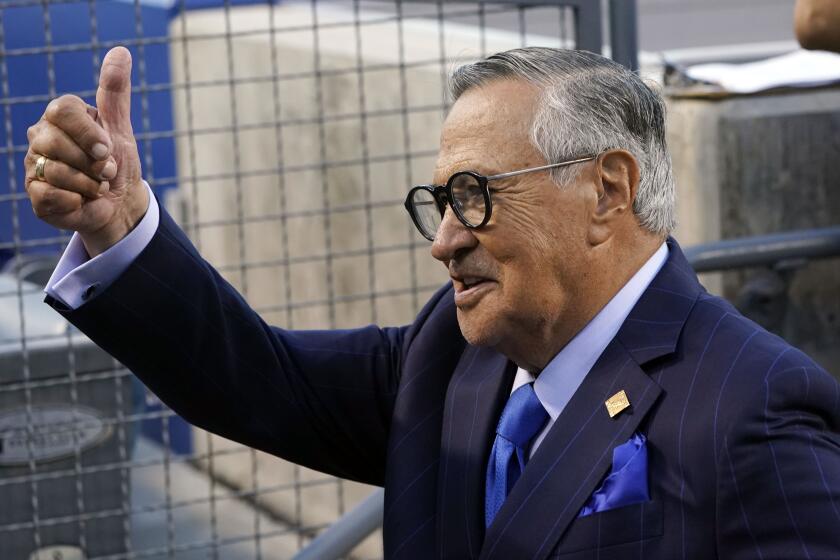 Jaime Jarrín, the Dodgers' Spanish-language broadcaster since 1959, waves to fans during a pregame ceremony Oct. 1, 2022.