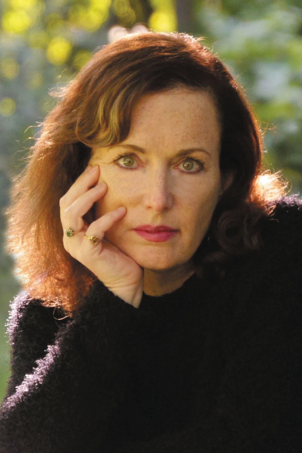 Author Alison Gaylin poses with her hand under her chin.