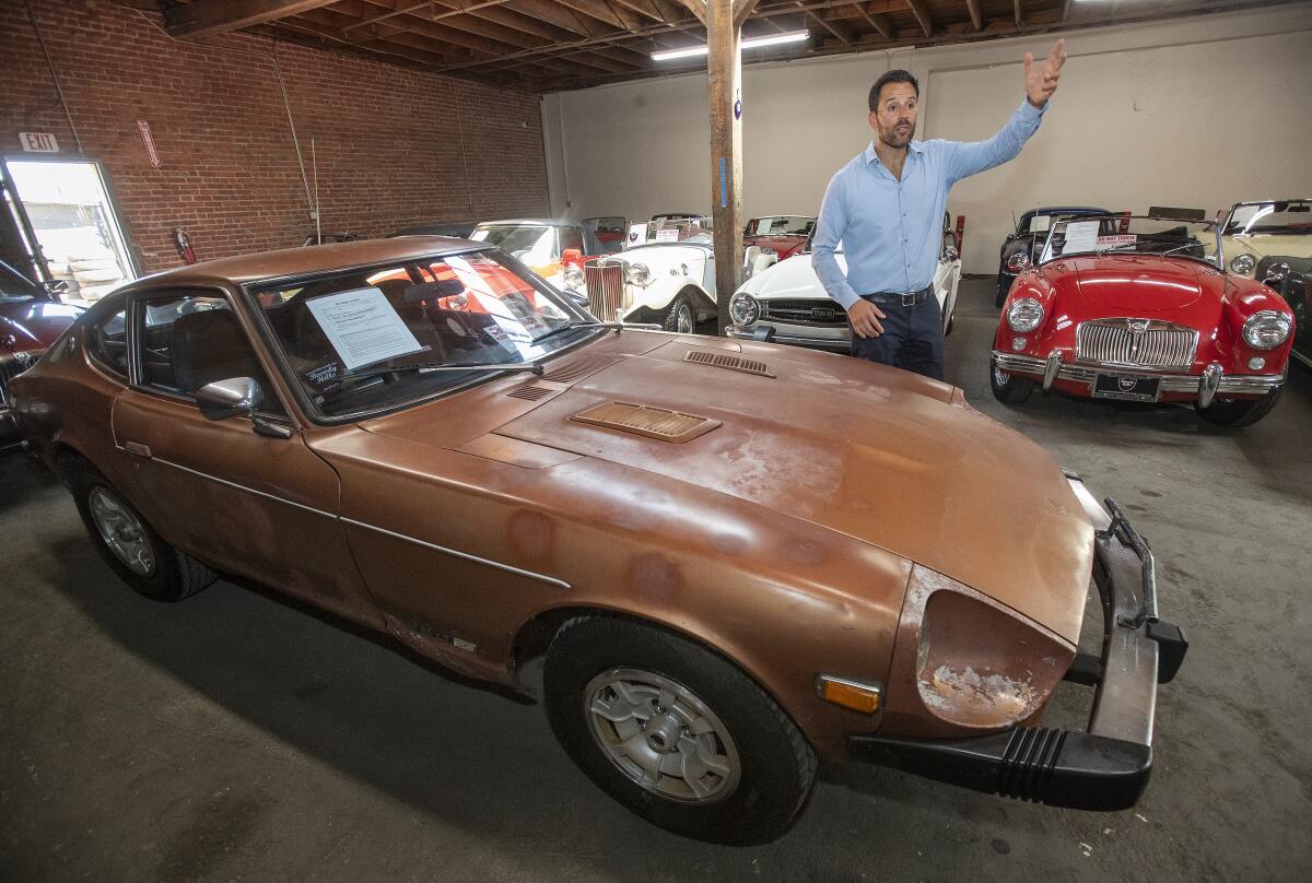 Beverly Hills Car Club owner Alex Manos is seen next to a 1977 Datsun 280Z.