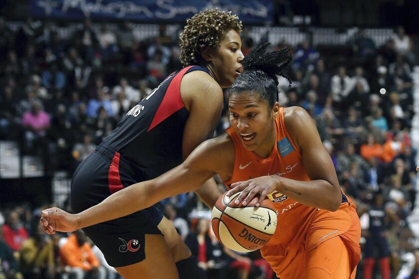 Connecticut Sun's Alyssa Thomas, front, drives past Washington Mystics' Tianna Hawkins during the first half in Game 4 of basketball's WNBA Finals, Tuesday, Oct. 8, 2019, in Uncasville, Conn. (AP Photo/Jessica Hill)
