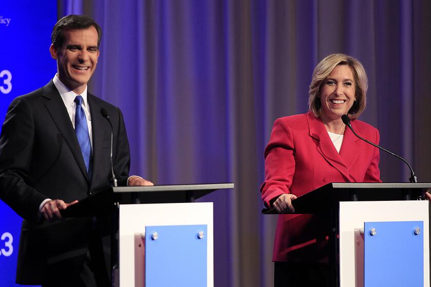 Los Angeles mayoral candidates Eric Garcetti and Wendy Greuel chat before they square off in a debate.