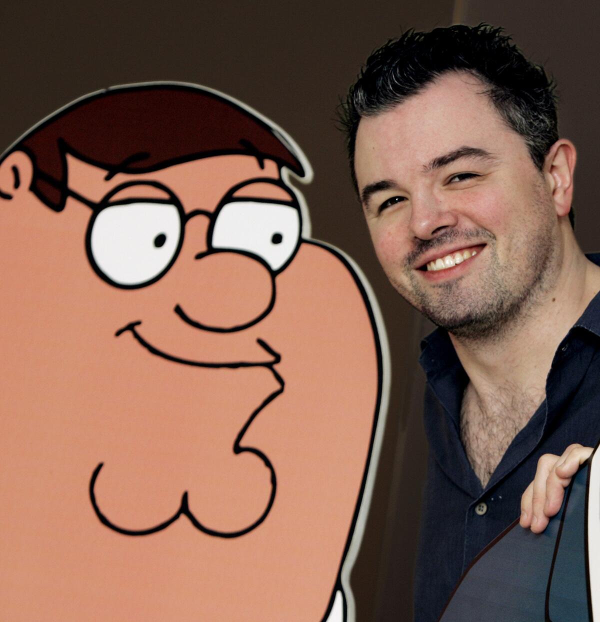 Seth MacFarlane, the creator of Fox's animated series "Family Guy," poses with a cutout of Peter Griffin on March 1, 2005, in Los Angeles.