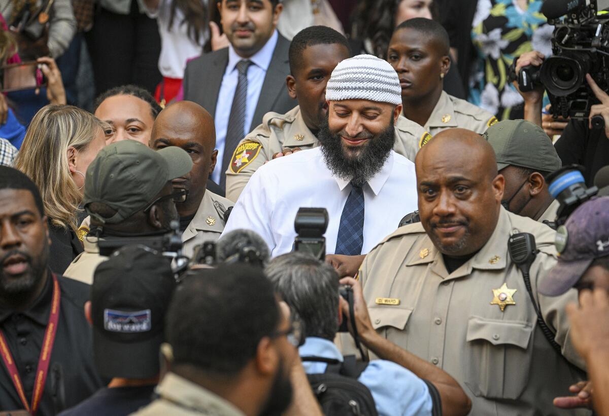 Adnan Syed exits the Cummings Courthouse surrounded by security and media 