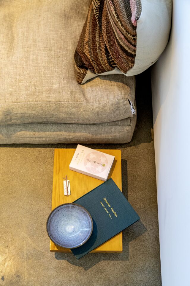 A book, tray and other items on a couch