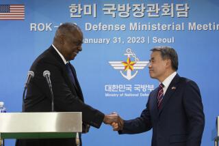 U.S. Secretary of Defense Lloyd Austin, left, shakes hands with South Korean Defense Minister Lee Jong-sup after a joint press conference after their meeting at the Defense Ministry in Seoul, South Korea, Tuesday, Jan. 31, 2023. (Jeon Heon-kyun/Pool Photo via AP)