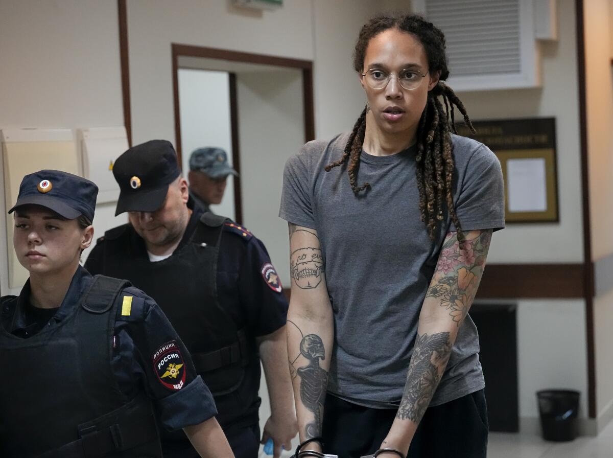 FILE - WNBA star and two-time Olympic gold medalist Brittney Griner is escorted from a court room ater a hearing, in Khimki just outside Moscow, Russia, Aug. 4, 2022. (AP Photo/Alexander Zemlianichenko, File)