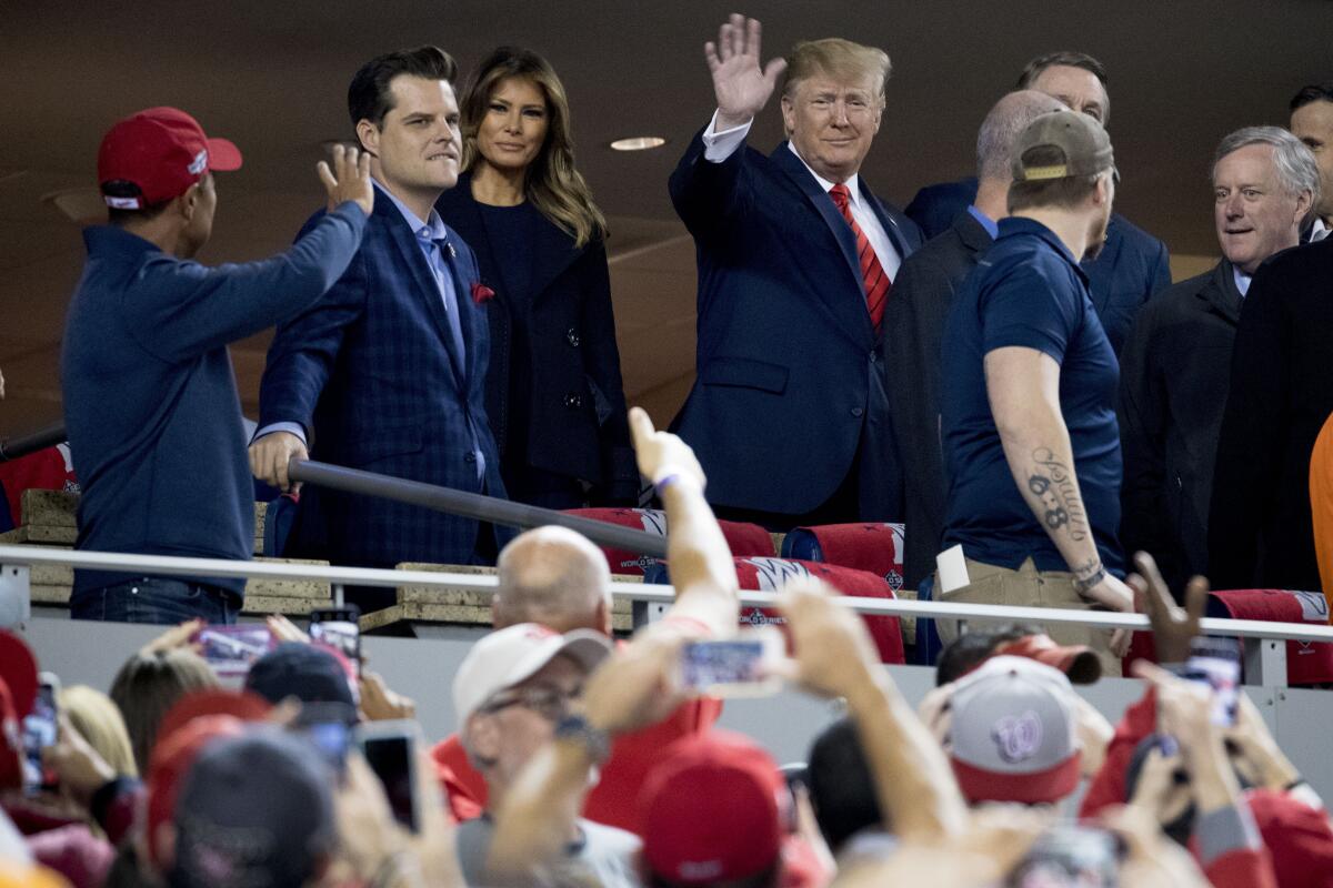 President Trump and First Lady Melania Trump arrive for Game 5 of the World Series on Oct. 27 at Nationals Park in Washington, where he was met with boos and chants of "Lock him up."