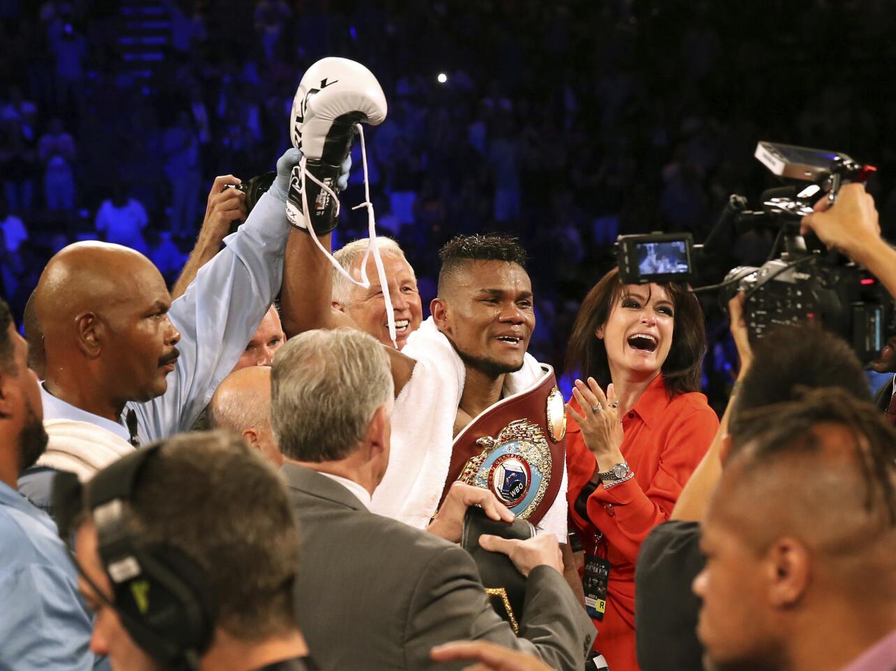 Eleider Alvarez, center, of Colombia, celebrates after he knocked out Sergey Kovalev, of Russia, in the seventh round of their boxing bout at 175 pounds, Saturday, Aug. 4, 2018, in Atlantic City, N.J.