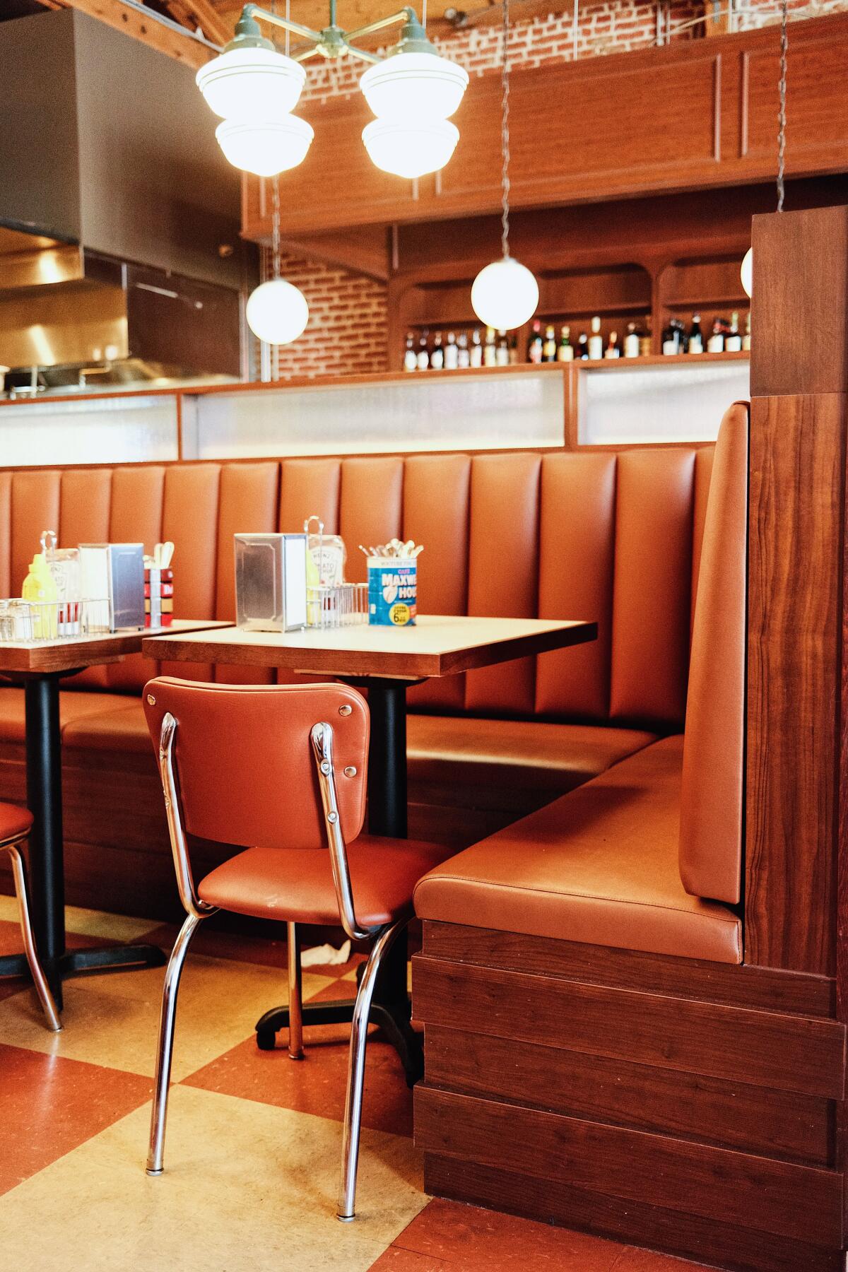 Vertical interior of a tan chair and booth at Belle's Deli