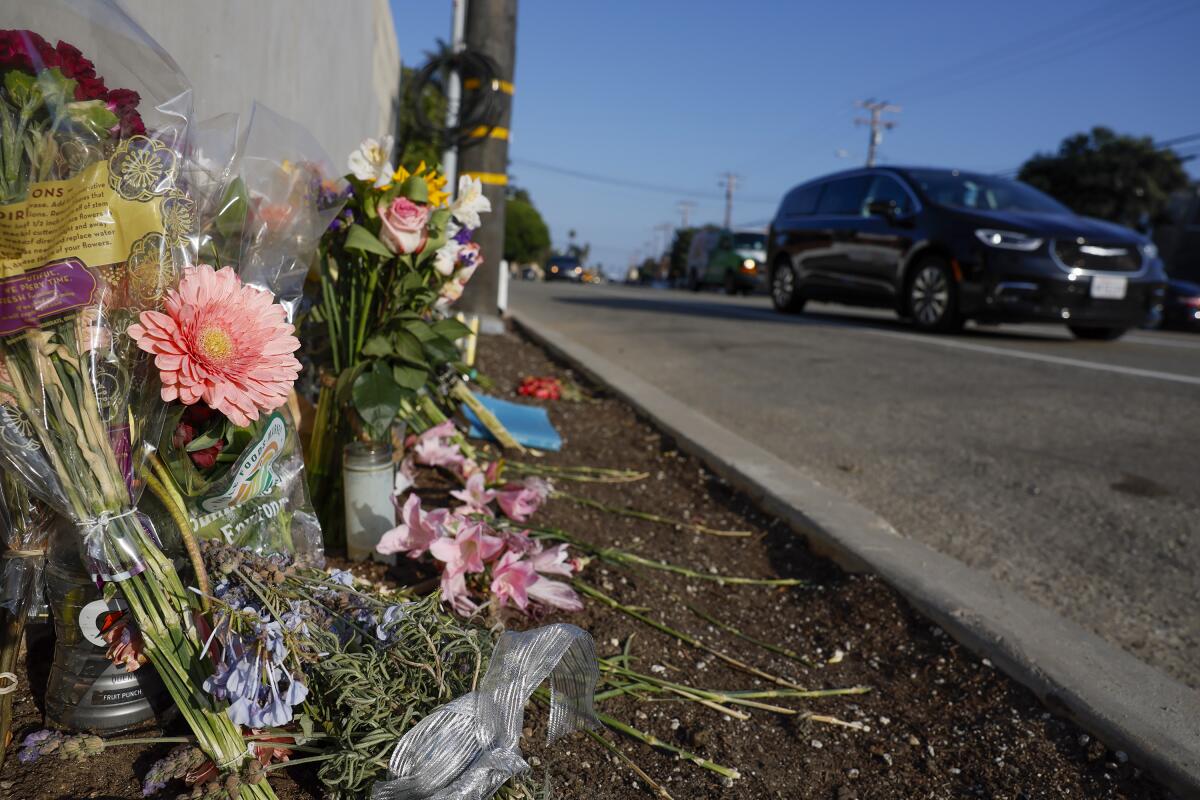 Flowers and other memorial items are seen on Pacific Coast Highway 