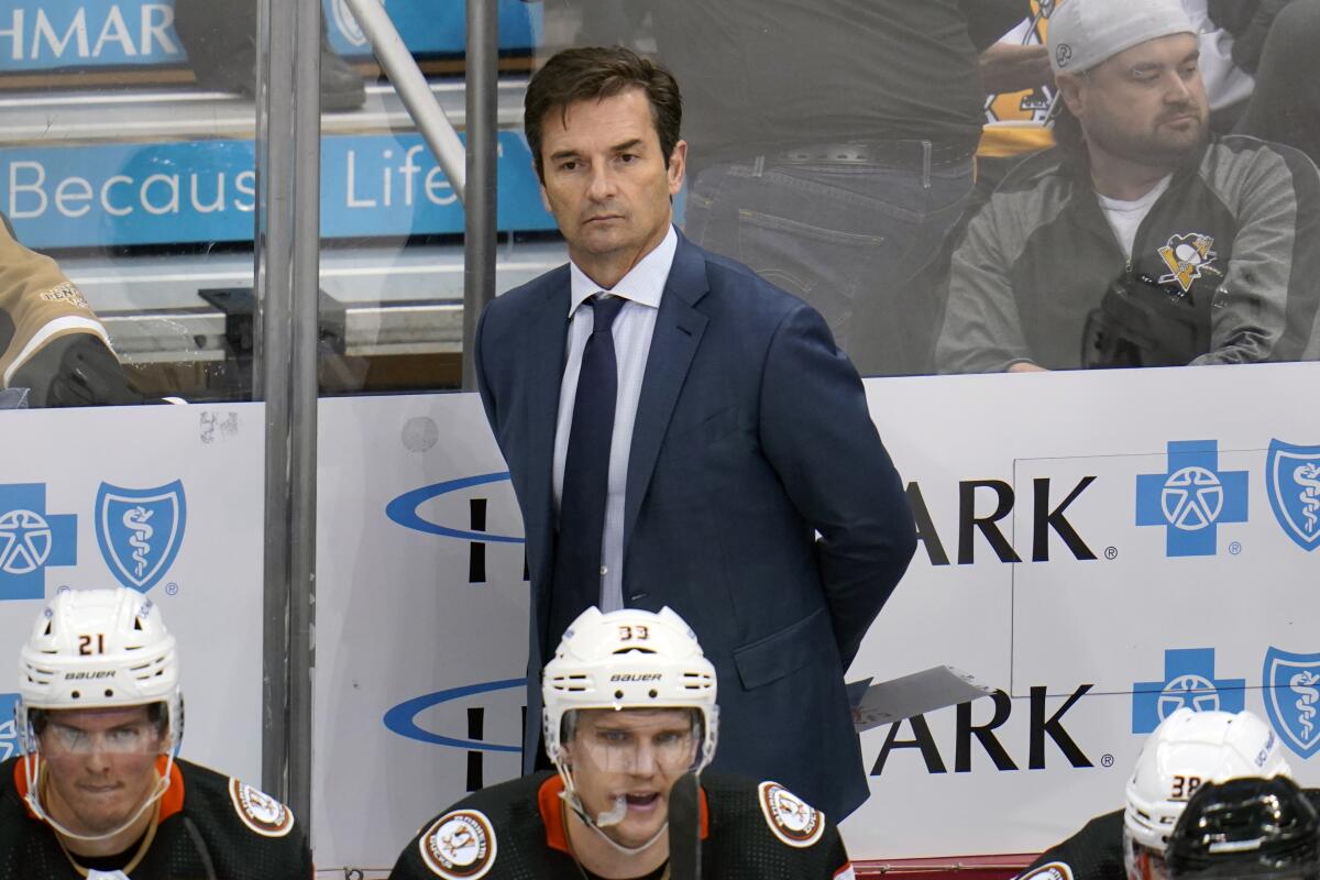Ducks coach Dallas Eakins stands behind the bench during a game against the Pittsburgh Penguins in December.