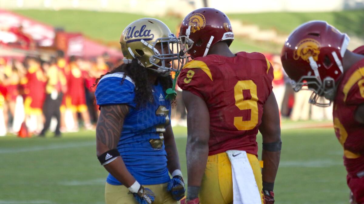 UCLA defensive back Randall Goforth and USC receiver JuJu Smith-Schuster exchange words during the second half of the Trojans' 40-21 win last season at the Coliseum.