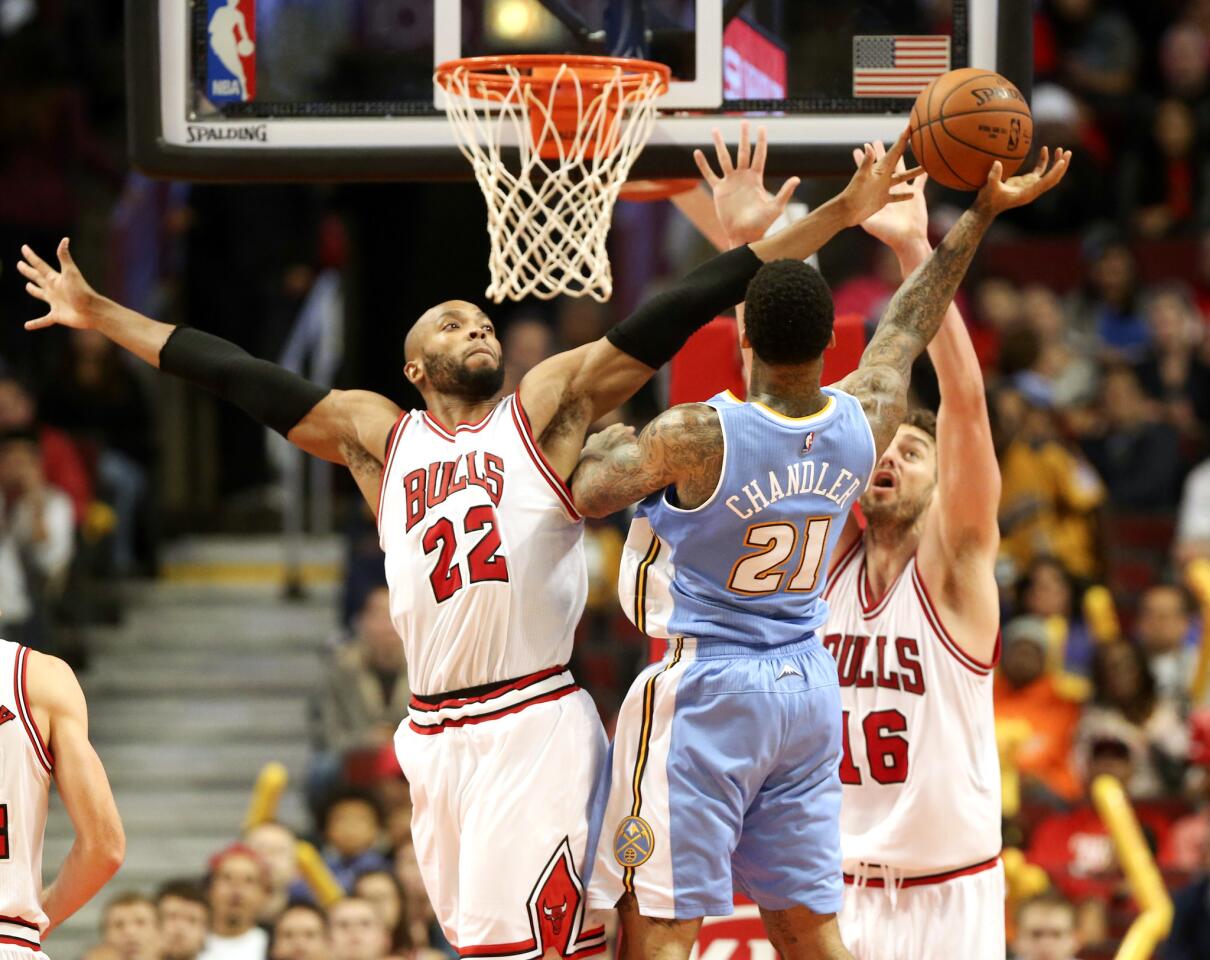 Taj Gibson and Pau Gasol defend against the Nuggets' Wilson Chandler during the second half.