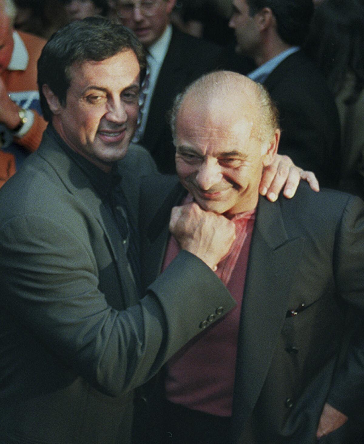 A smiling Sylvester Stallone poses as if he's slugging "Rocky" co-star Burt Young. 