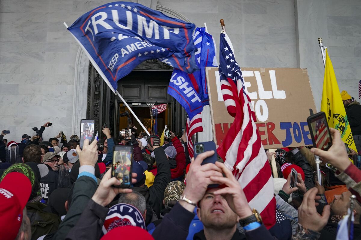 Trump supporters gather outside the Capitol, Wednesday, Jan. 6, 2021, in Washington. (AP Photo/John Minchillo)
