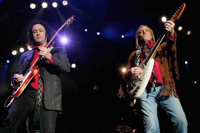 Mike Campbell and Tom Petty perform at the Vegoose music festival at Sam Boyd Stadium's Star Nursery Field n Las Vegas, Nevada.