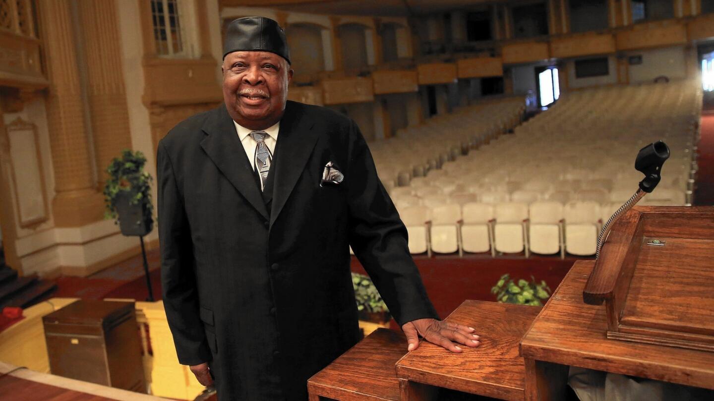 The Rev. Lincoln Scott stands in 2013 at the front of the House of Prayer Church of God in Christ in the North Lawndale neighborhood. Scott resurrected the historic Central Park Theatre and turned it into the church. Scott died on Aug. 28 in his South Austin home at 82. Read the obituary.