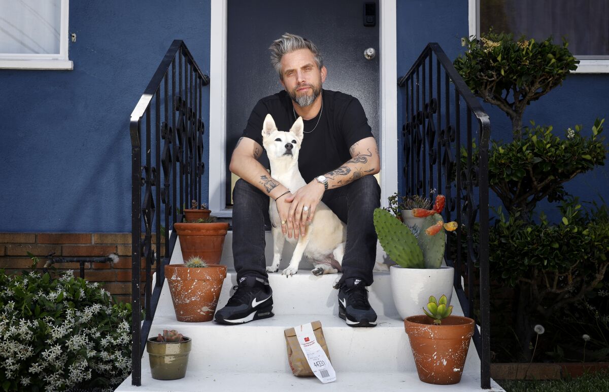 Richie Kulchar sits on his doorstep with his dog and an unwanted Uber Eats order.