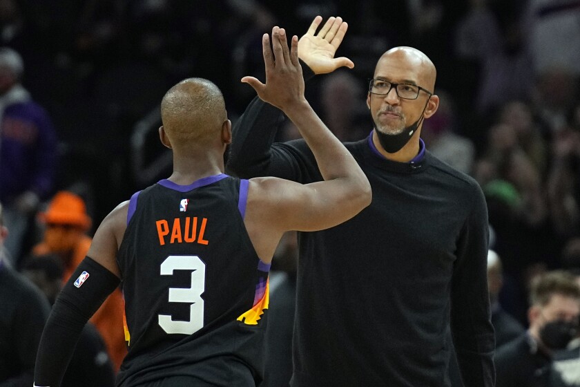 Phoenix Suns coach Monty Williams and guard Chris Paul (3) reacts after a timeout during the second half of the team's NBA basketball game against the Los Angeles Clippers, Thursday, Jan. 6, 2022, in Phoenix. The Suns won 106-89. (AP Photo/Rick Scuteri)