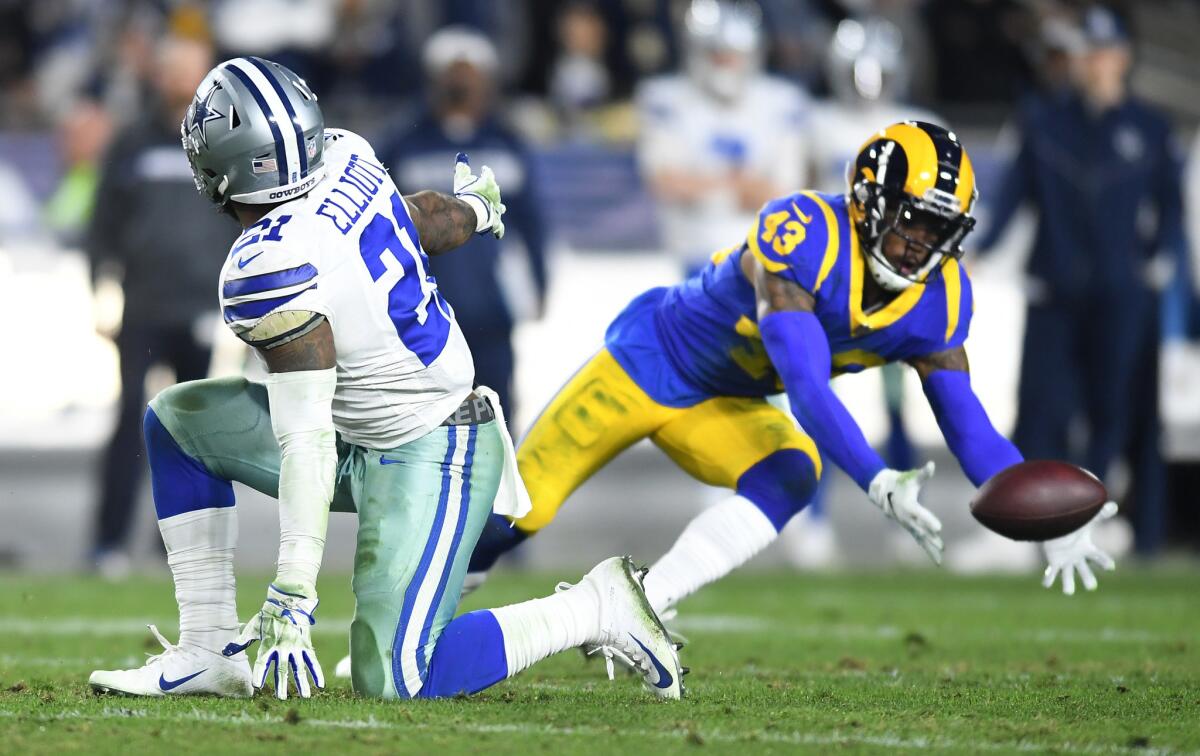 Rams safety John Johnson almost intercepts a pass as Cowboys running back Ezekiel Elliott watches.