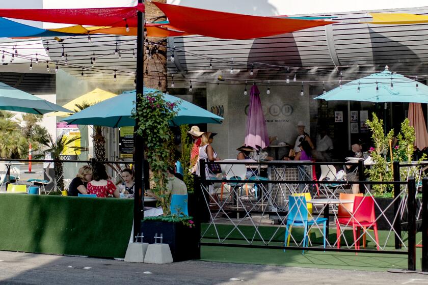 PALM SPRINGS, CA - SEPTEMBER 15, 2020: Umbrellas, misters and extended outdoor seating at Lulu's restaurant on September 15, 2020 in downtown Palm Springs, California. About 5 blocks of South Palm Canyon Drive is closed to cars so restaurants can offer extended outdoor seating during the coronavirus pandemic.(Gina Ferazzi / Los Angeles Times)