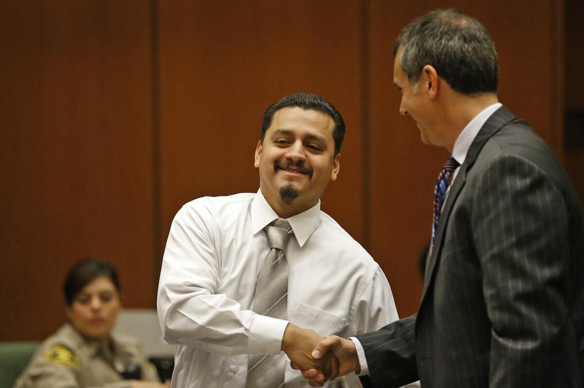 Gabriel Carrillo, left, who was beaten and framed by sheriff's deputies in 2011 during a visit to Men's Central Jail, shakes hands with his attorney, Ron Kaye, after Friday's hearing. A judge found Carrillo was factually innocent in the case.