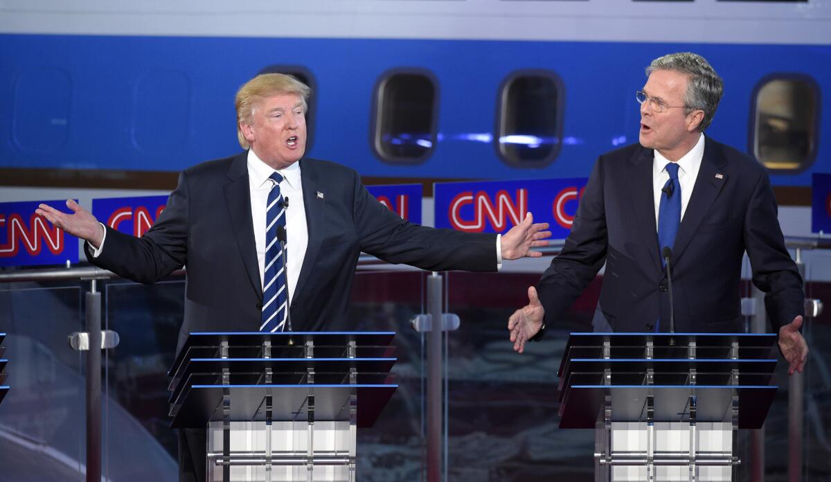 Republican presidential candidates, former Florida Gov. Jeb Bush, right, and Donald Trump both speak during the CNN Republican presidential debate at the Ronald Reagan Presidential Library and Museum on Wednesday, Sept. 16, 2015, in Simi Valley, Calif. (AP Photo/Mark J. Terrill)