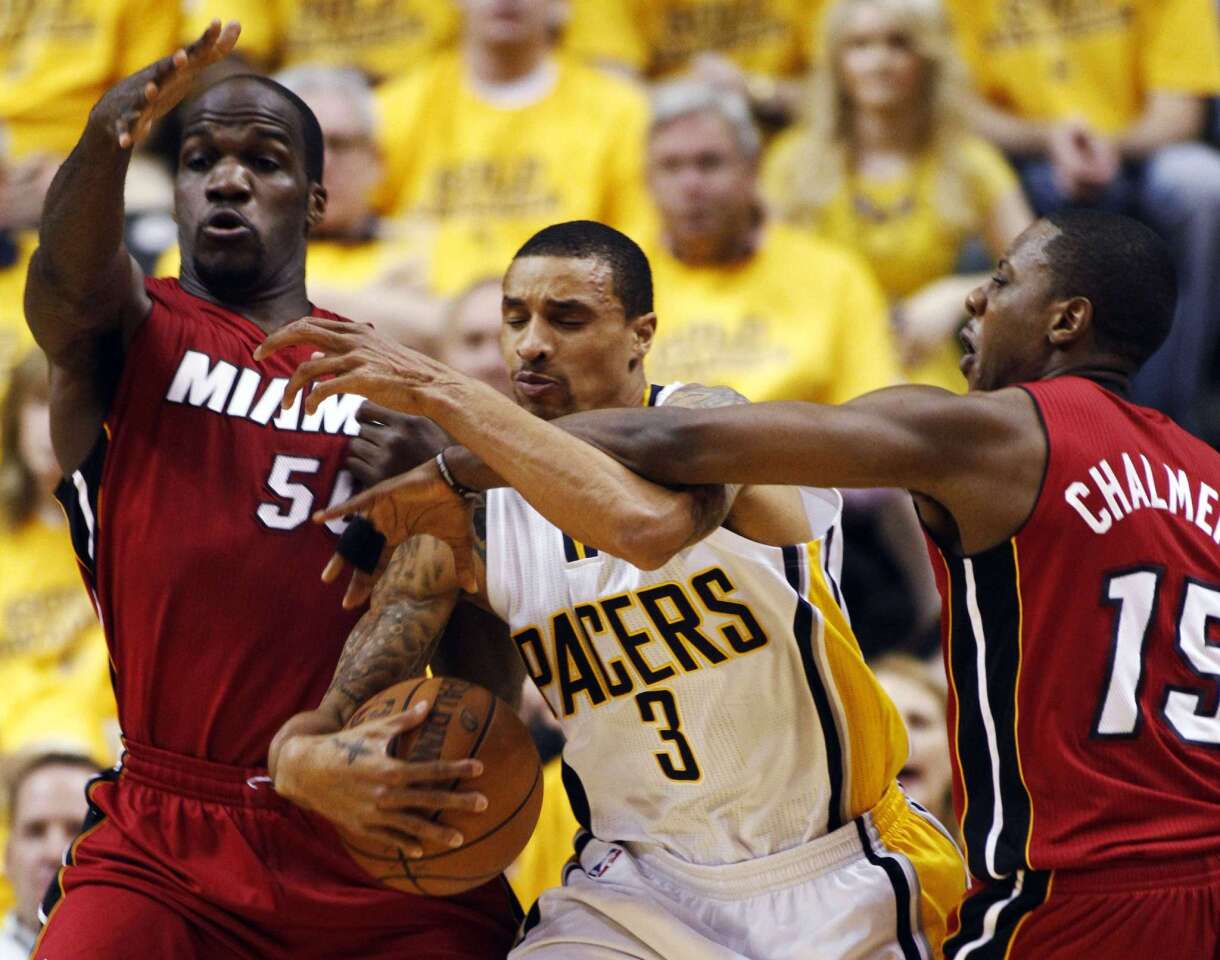 Indiana Pacers' Hill is defended by Miami Heat's Anthony and Chalmers during their NBA Eastern Conference basketball playoff in Indianapolis