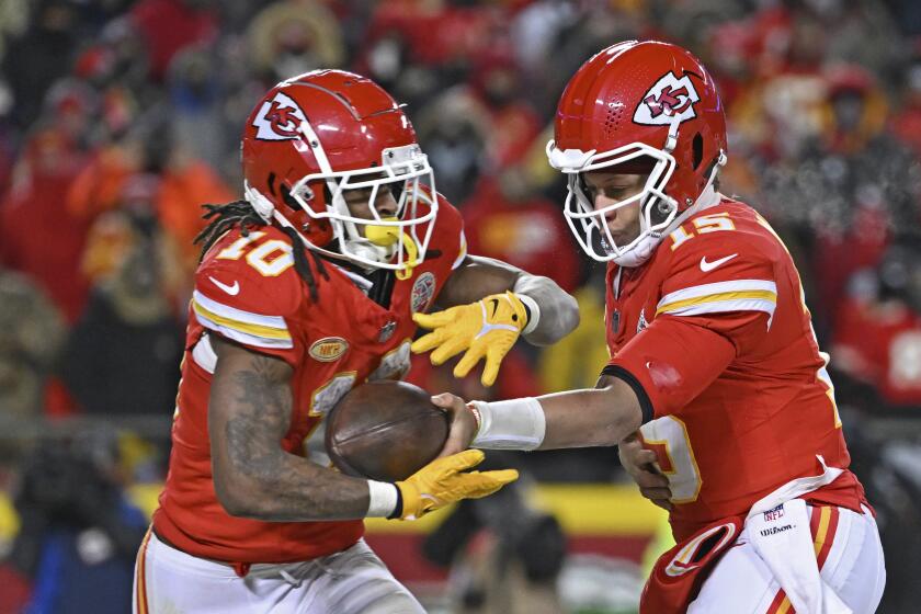 Kansas City Chiefs quarterback Patrick Mahomes hands off the ball to running back Isiah Pacheco.