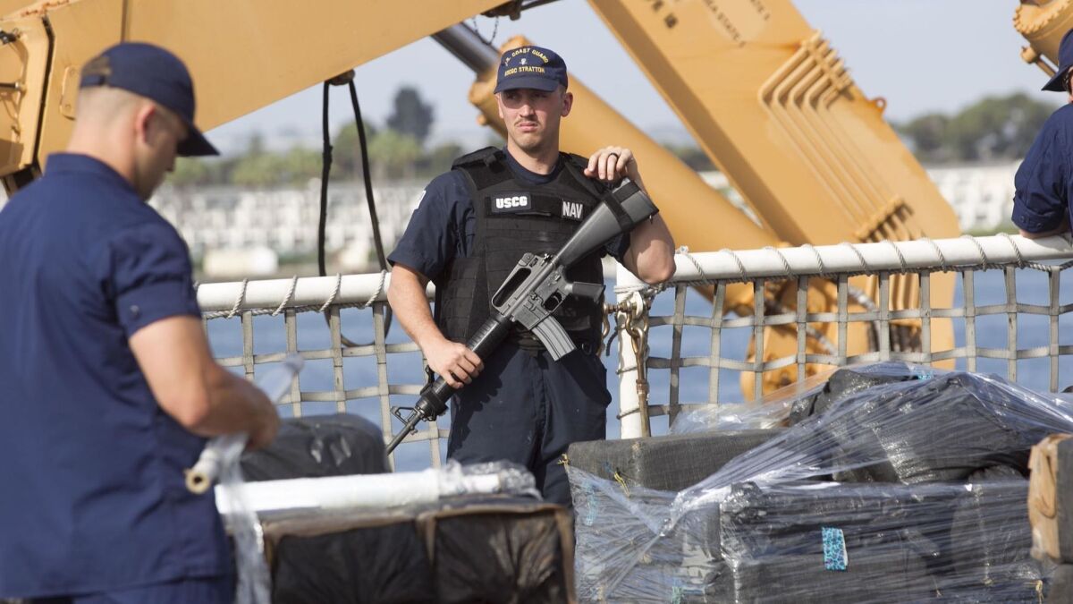 Eleven tons of cocaine were unloaded from a Coast Guard cutter Wednesday morning at the 10th Avenue Marine Terminal. An armed crew member keeps watch on the ship's deck.