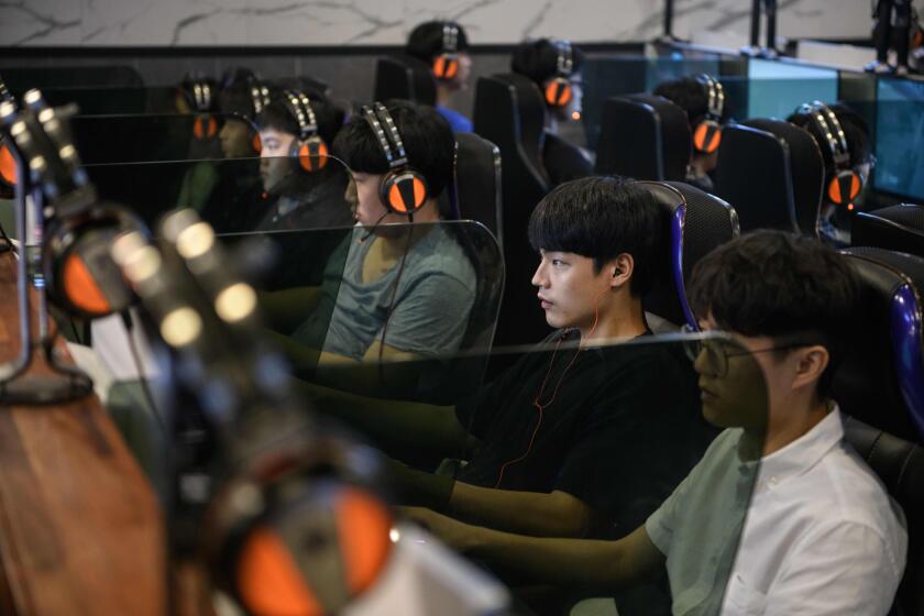 In a photo taken on July 13, 2018, customers play computer games at an eSports cafe, or "PC Bang", in Seoul. - South Korea enjoys ultra-fast broadband and a vibrant Internet culture, and internet cafes armed with powerful high-end computers catering to school-age gamers can be found on many street corners. (Photo by Ed JONES / AFP) / TO GO WITH SKorea-eSports, FOCUS by JUNG Hawon (Photo credit should read ED JONES/AFP/Getty Images)