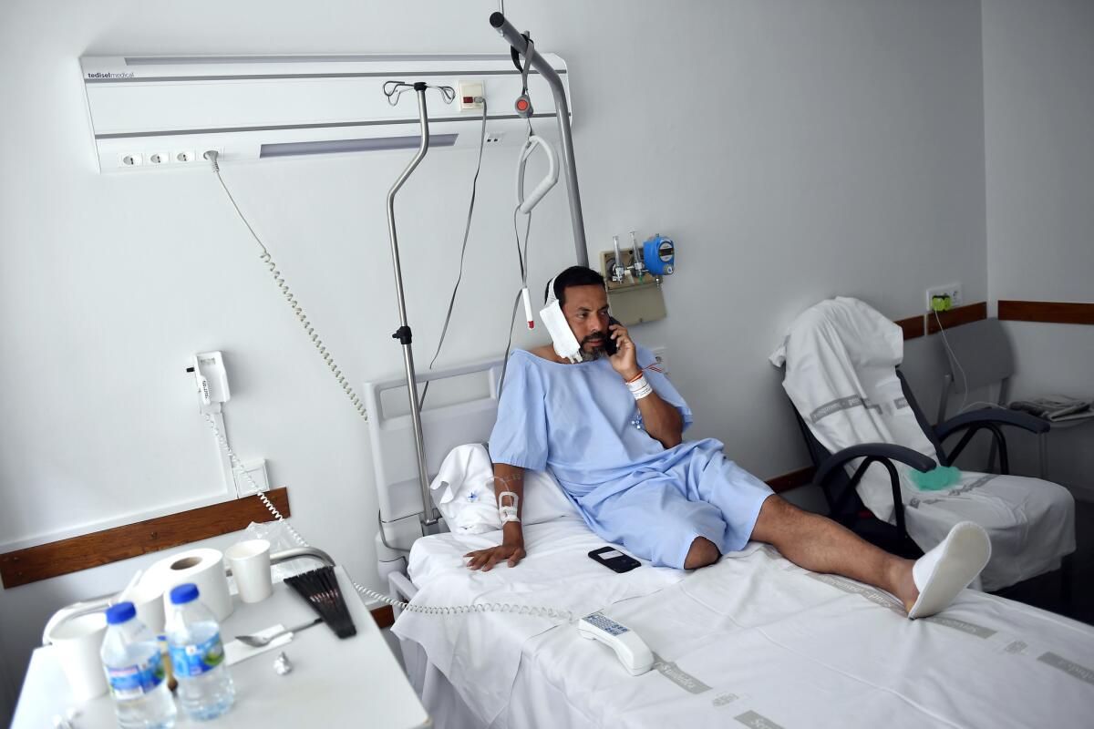 Jaime Alvarez, a lawyer from California, sits in a hospital in Pamplona after being gored by a bull. (Alvaro Barrientos / Associated Press)