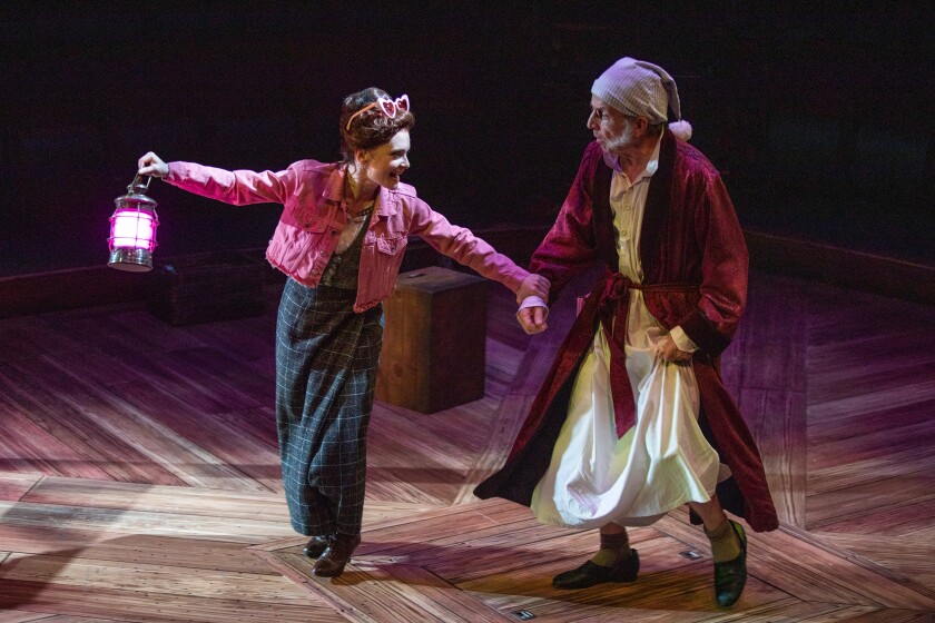 Cathryn Wake as the Ghost of Christmas Present and Robert Joy as Scrooge in "Ebenezer Scrooge's BIG San Diego Christmas Show" at the Old Globe Theatre.