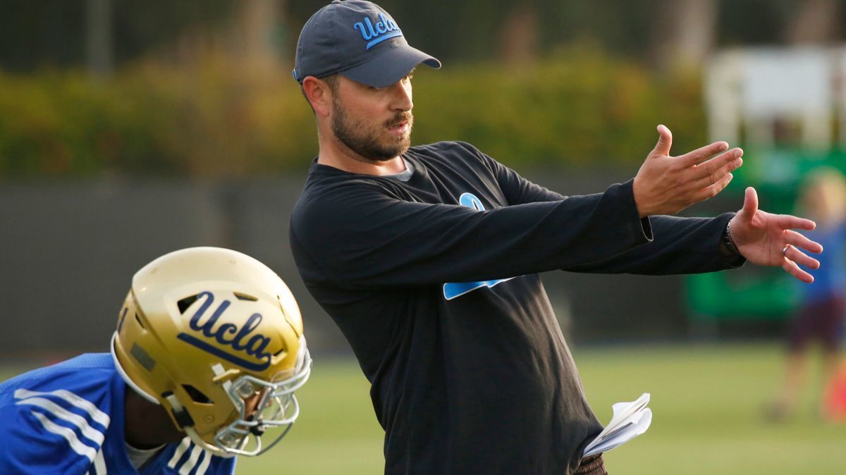 UCLA wide receivers coach Jimmie Dougherty coaches a player during spring practice.