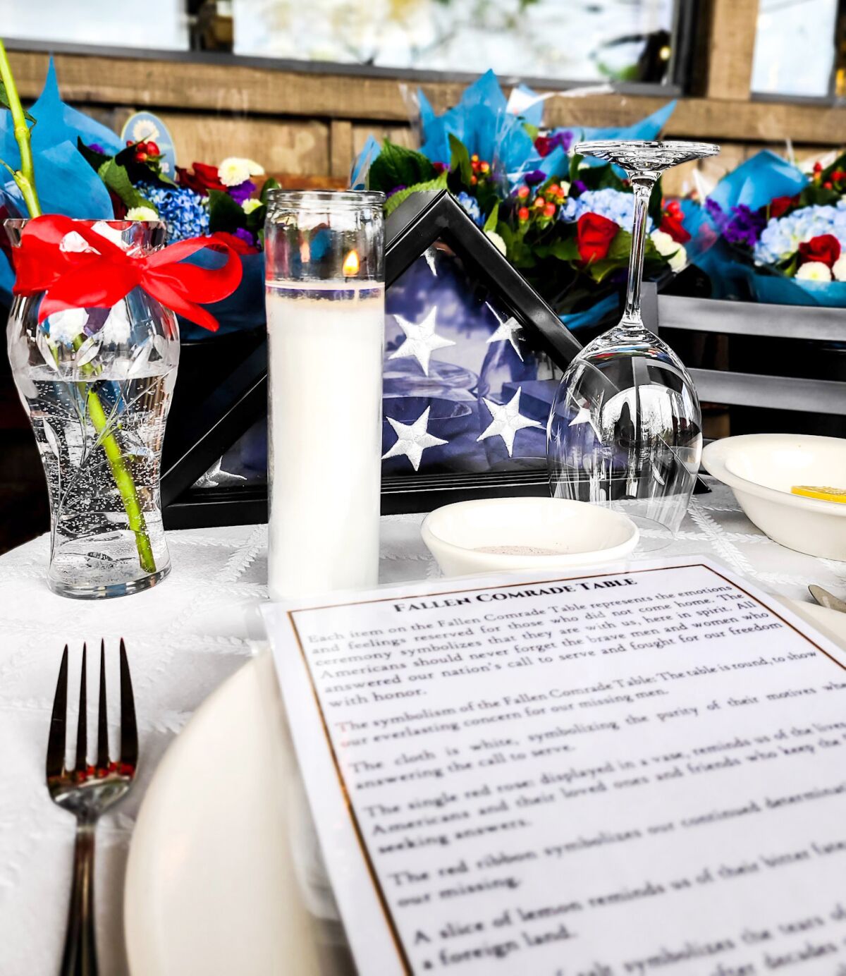 A Missing Man Table set up at Ramona Family Naturals Market is filled with symbols in honor of military members.